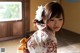 A woman in a kimono with a flower in her hair.