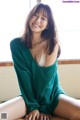 A woman sitting on top of a wooden table.