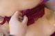 A close up of a woman wearing a purple bra.