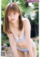 A woman in a blue bikini posing for a picture.
